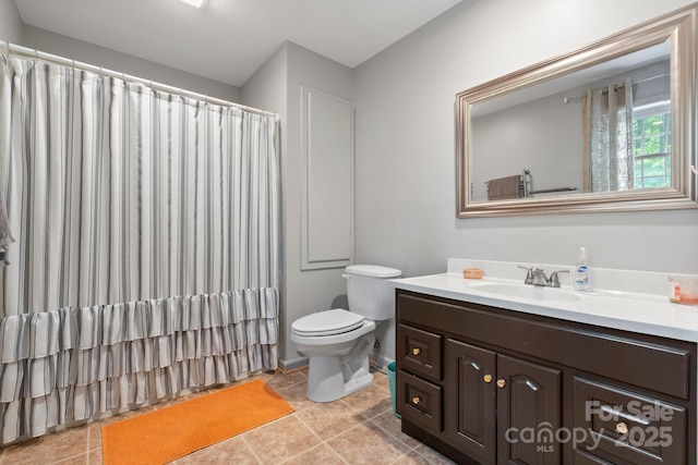bathroom featuring vanity, tile patterned flooring, curtained shower, and toilet
