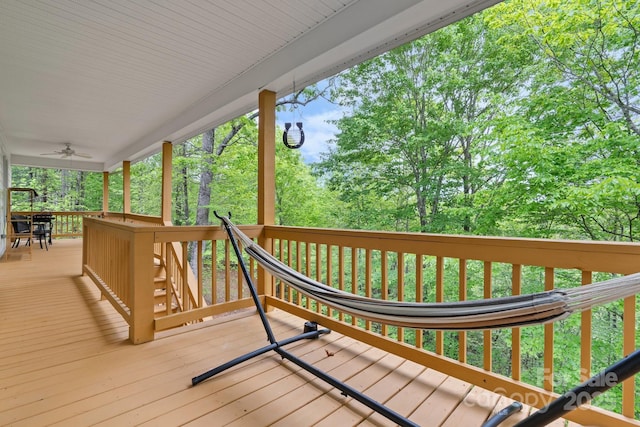 wooden terrace with a ceiling fan