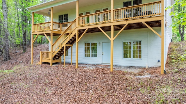 back of property with stairs and a wooden deck