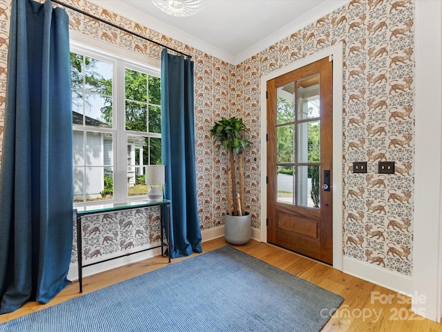 1614 Brook Rd, Charlotte, NC 28205 - doorway to outside with wallpapered walls, plenty of natural light, wood finished floors, and crown molding