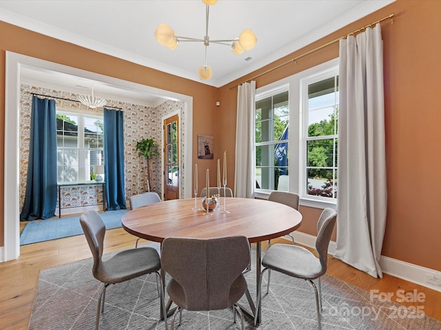 1614 Brook Rd, Charlotte, NC 28205 - dining area featuring wood finished floors, baseboards, ornamental molding, and a notable chandelier