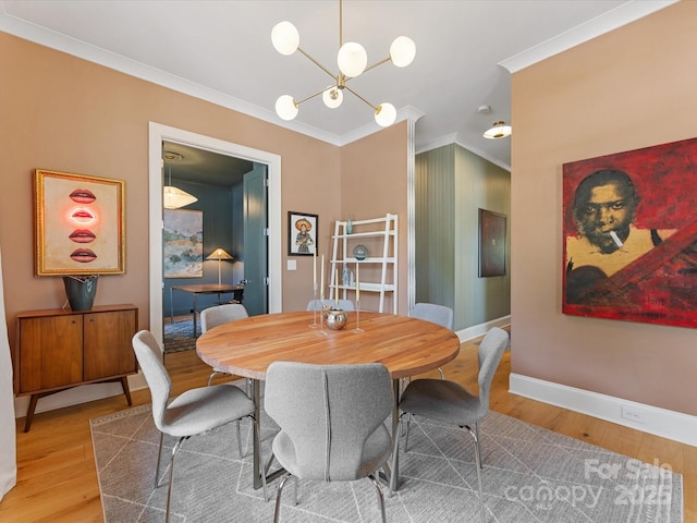 1614 Brook Rd, Charlotte, NC 28205 - dining space with crown molding, a chandelier, baseboards, and light wood-style flooring