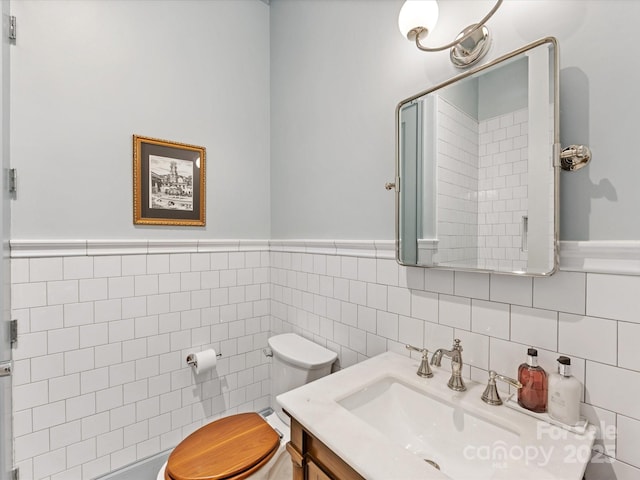 1614 Brook Rd, Charlotte, NC 28205 - bathroom featuring tile walls, toilet, a wainscoted wall, and vanity