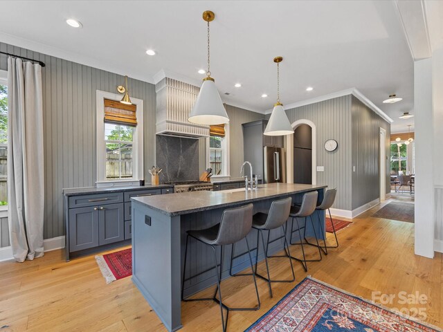 1614 Brook Rd, Charlotte, NC 28205 - kitchen featuring crown molding, a breakfast bar, a sink, and high end refrigerator