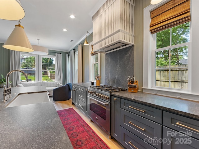 1614 Brook Rd, Charlotte, NC 28205 - kitchen with a healthy amount of sunlight, a sink, high end stove, and custom range hood