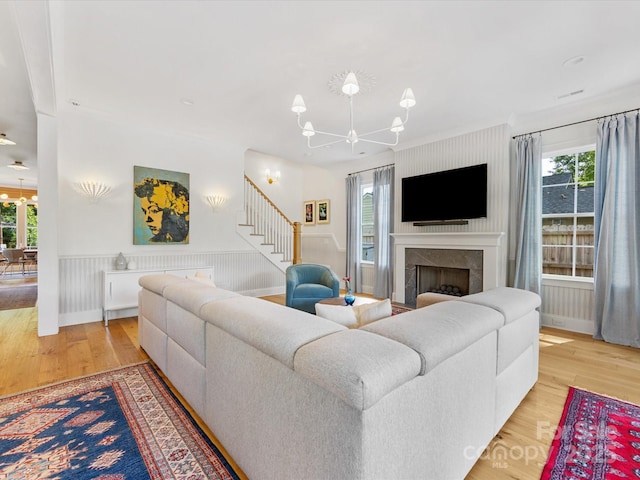 1614 Brook Rd, Charlotte, NC 28205 - living room with a wealth of natural light, wood finished floors, stairs, and a notable chandelier