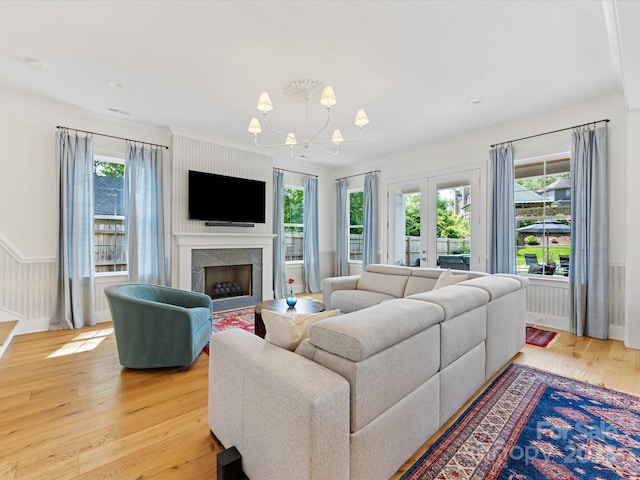 1614 Brook Rd, Charlotte, NC 28205 - living area featuring light wood finished floors, a high end fireplace, and a notable chandelier