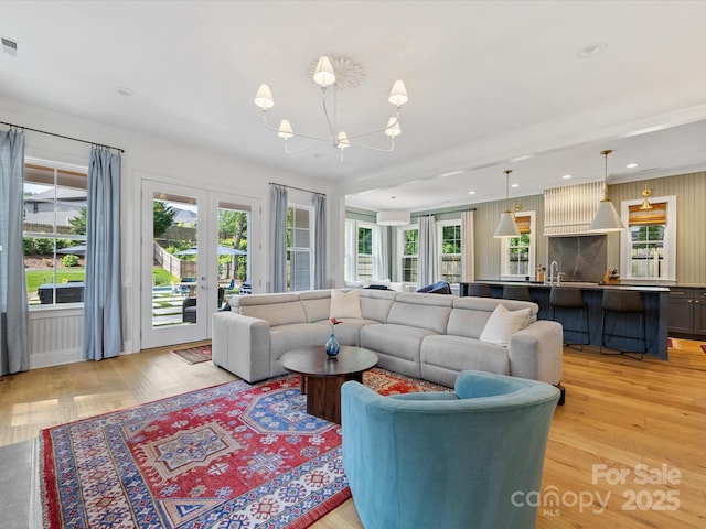 1614 Brook Rd, Charlotte, NC 28205 - living room featuring a notable chandelier, light wood-style flooring, recessed lighting, french doors, and visible vents