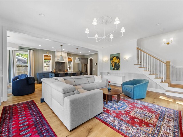 1614 Brook Rd, Charlotte, NC 28205 - living area featuring a chandelier, stairs, arched walkways, and wood finished floors