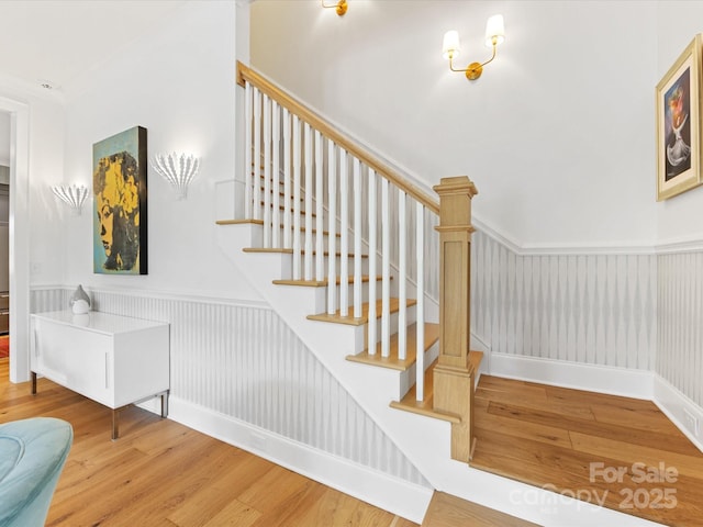 1614 Brook Rd, Charlotte, NC 28205 - stairway featuring baseboards, wainscoting, and wood finished floors