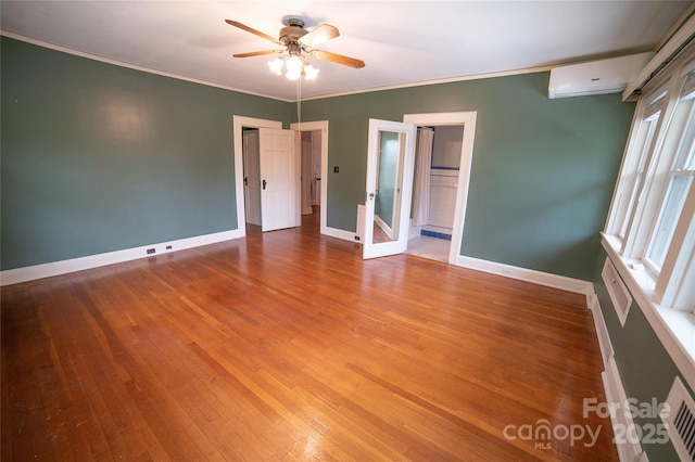 311 W Union St, Morganton, NC 28655 - interior space featuring french doors, a wall mounted air conditioner, hardwood / wood-style floors, baseboards, and ceiling fan