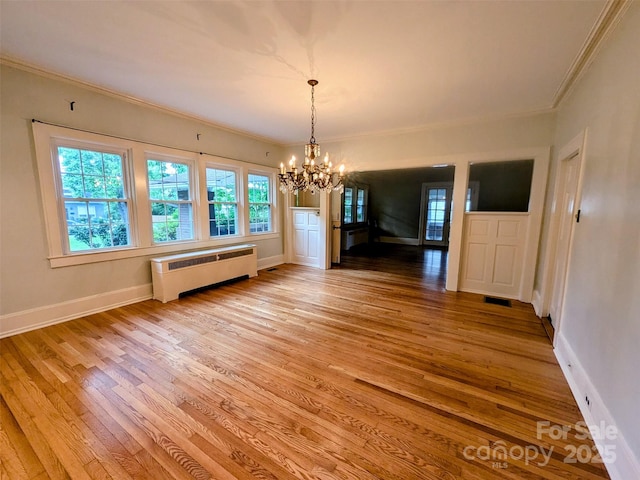 311 W Union St, Morganton, NC 28655 - unfurnished dining area with an inviting chandelier, light wood-style flooring, radiator, visible vents, and ornamental molding