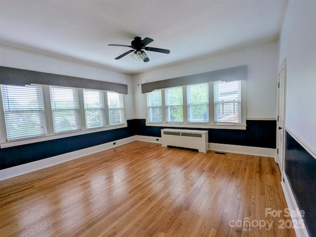 311 W Union St, Morganton, NC 28655 - spare room featuring radiator, a ceiling fan, visible vents, and light wood-style floors