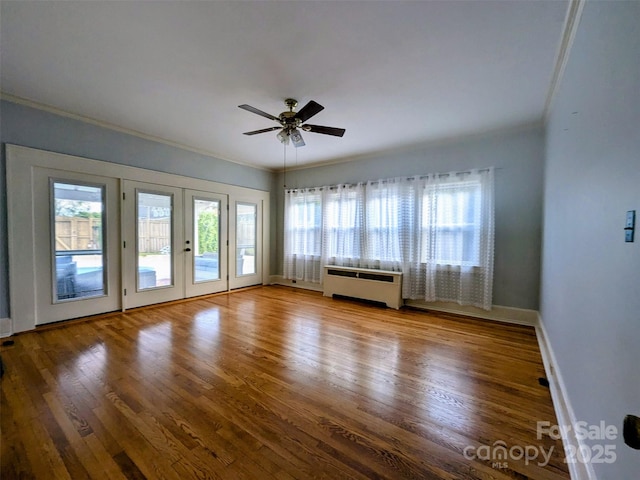 311 W Union St, Morganton, NC 28655 - unfurnished room featuring radiator heating unit, plenty of natural light, and wood finished floors