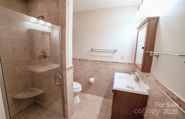 311 W Union St, Morganton, NC 28655 - full bathroom featuring tile walls, toilet, a wainscoted wall, vanity, and a shower stall