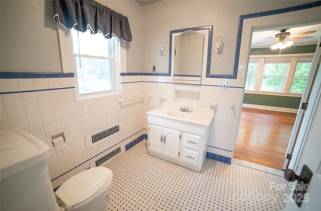 311 W Union St, Morganton, NC 28655 - bathroom featuring a ceiling fan, tile walls, wainscoting, visible vents, and vanity
