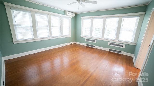 311 W Union St, Morganton, NC 28655 - unfurnished room with ceiling fan, visible vents, wood finished floors, and a wall unit AC