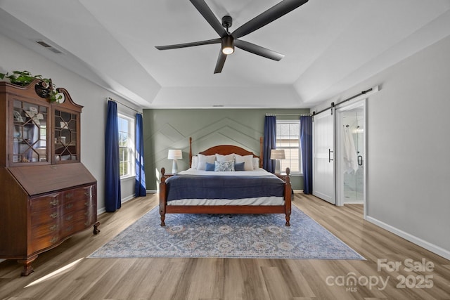 347 Wildbriar Rd Unit 28, Fletcher, NC 28732 - bedroom featuring a raised ceiling, wood finished floors, baseboards, and a barn door
