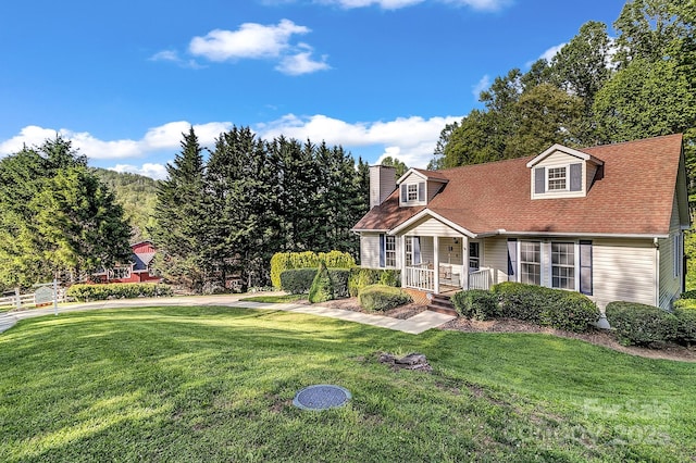 cape cod-style house with covered porch, a chimney, and a front yard