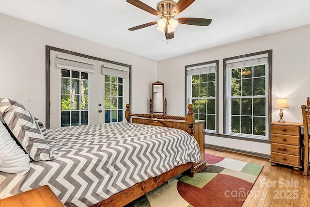 bedroom featuring ceiling fan, french doors, visible vents, access to outside, and hardwood / wood-style floors