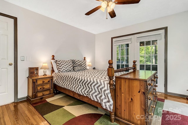 bedroom featuring ceiling fan, french doors, and wood finished floors