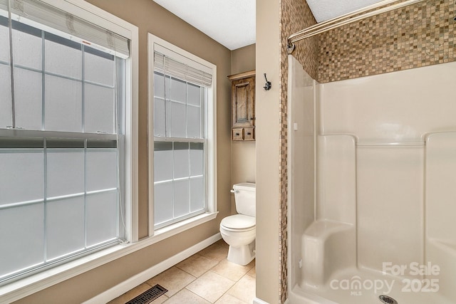 full bath featuring visible vents, a shower, toilet, baseboards, and tile patterned floors