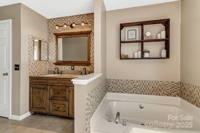 full bath with a garden tub, a sink, tile patterned floors, and double vanity