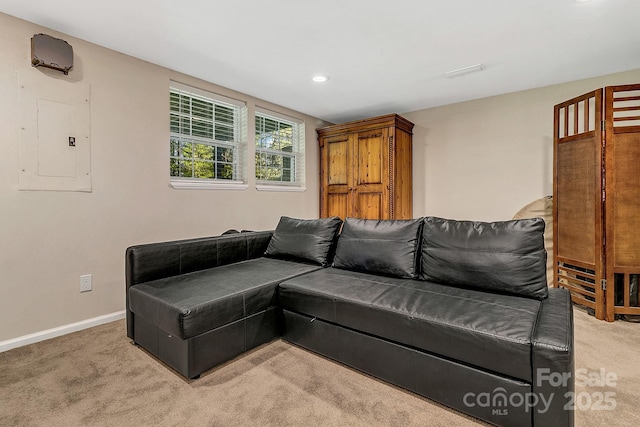 living area with light colored carpet, recessed lighting, baseboards, and electric panel