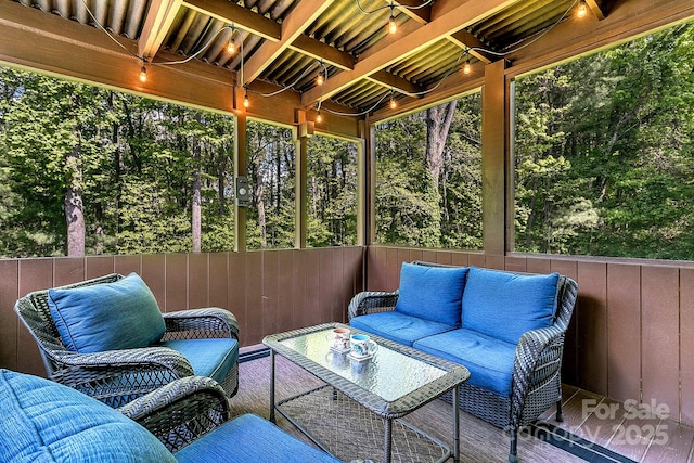 sunroom / solarium featuring plenty of natural light and an outdoor hangout area