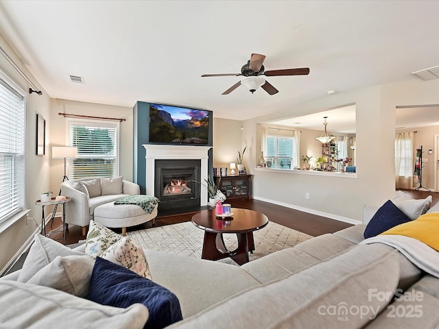 living room with visible vents, ceiling fan, and a healthy amount of sunlight