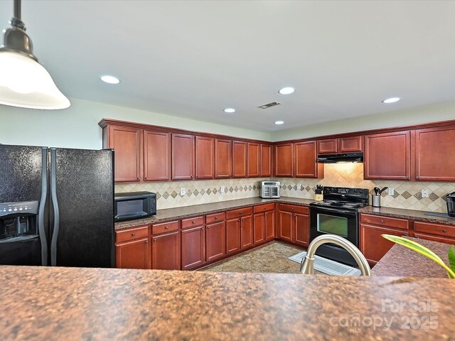 kitchen featuring black appliances, decorative backsplash, under cabinet range hood, and visible vents