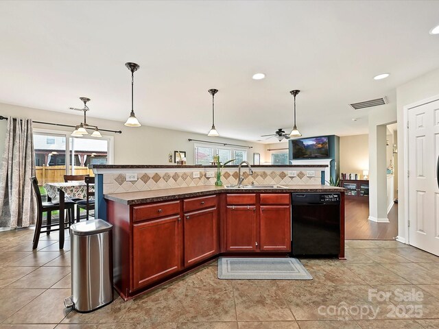 kitchen with plenty of natural light, a sink, backsplash, and black dishwasher