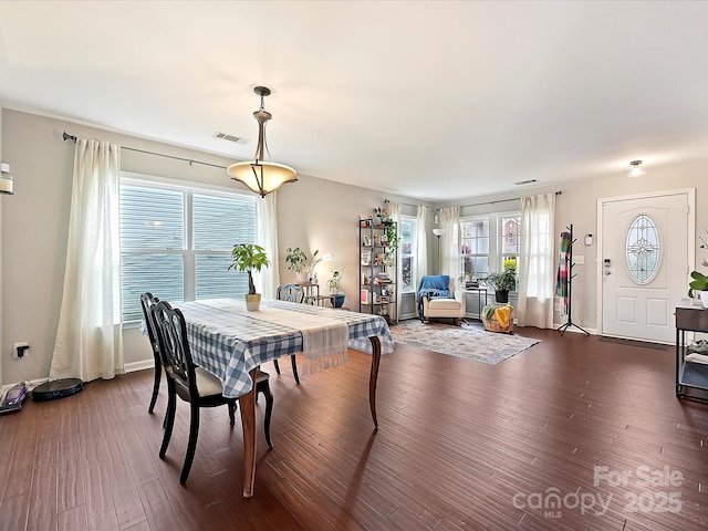 dining room featuring dark wood-style floors and visible vents