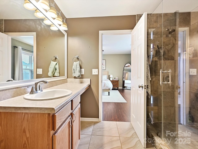 bathroom with a shower stall, tile patterned floors, vanity, and connected bathroom