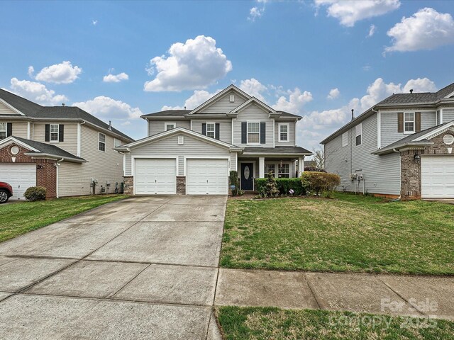 traditional-style home with an attached garage, a front lawn, and driveway