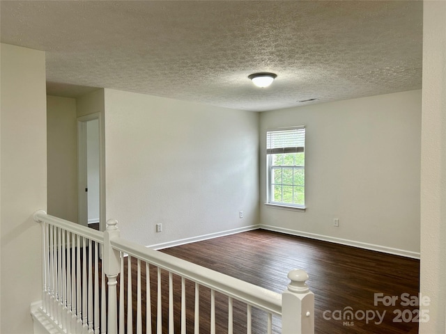 12713 Frank Wiley Ln, Charlotte, NC 28278 - empty room with dark wood-style floors, baseboards, and a textured ceiling