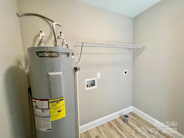 laundry room with water heater, electric dryer hookup, hookup for a washing machine, light wood-style flooring, and baseboards