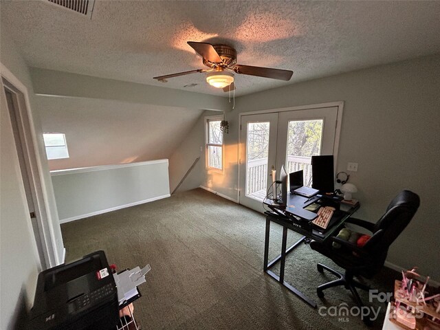 carpeted home office featuring visible vents, a textured ceiling, a ceiling fan, and french doors
