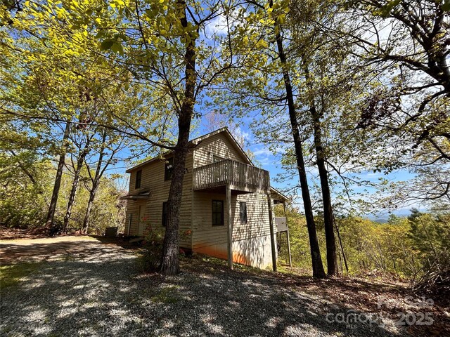 view of side of property featuring a balcony