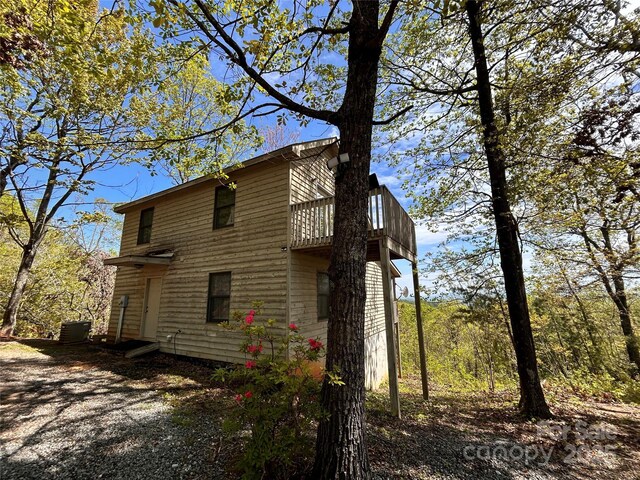 view of side of property with a balcony