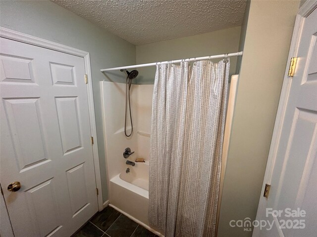 full bathroom featuring shower / tub combo, a textured ceiling, and tile patterned flooring