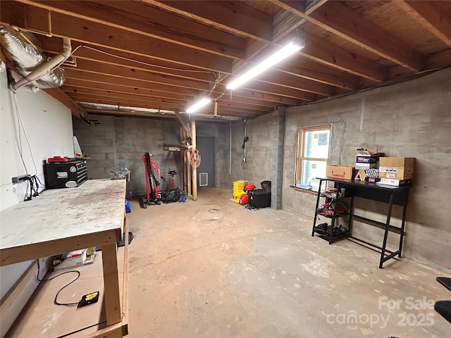 basement featuring a workshop area and visible vents