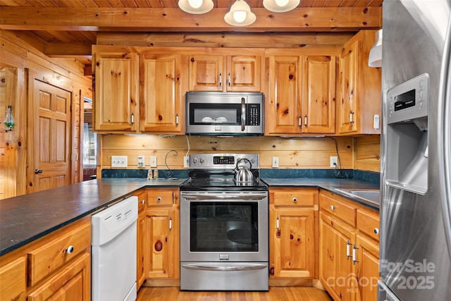 3110 Mentink Way, Nebo, NC 28761 - kitchen featuring appliances with stainless steel finishes, wood ceiling with exposed beams, dark countertops, light wood-type flooring, and brown cabinets