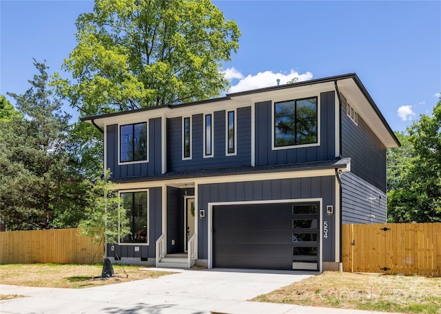 554 W Cama St, Charlotte, NC 28217 - view of front of home featuring a garage, driveway, and board and batten siding
