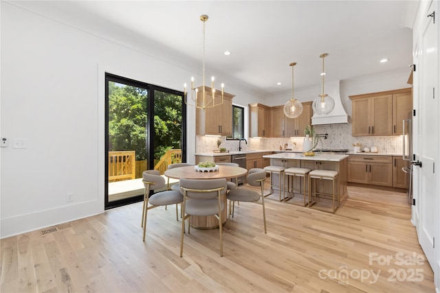 554 W Cama St, Charlotte, NC 28217 - dining room featuring light wood-type flooring, recessed lighting, crown molding, and a chandelier