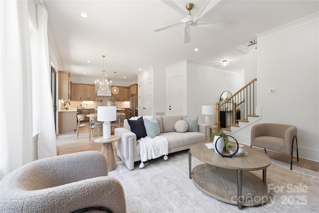 554 W Cama St, Charlotte, NC 28217 - living room with recessed lighting, stairway, light wood-type flooring, a ceiling fan, and a chandelier