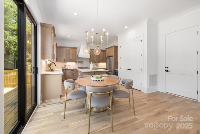 554 W Cama St, Charlotte, NC 28217 - dining area with light wood-style flooring, a chandelier, ornamental molding, and recessed lighting