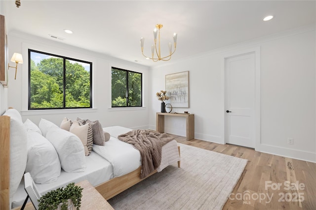 554 W Cama St, Charlotte, NC 28217 - bedroom with a chandelier, light wood finished floors, baseboards, recessed lighting, and ornamental molding