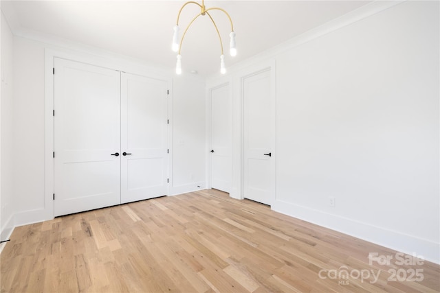 554 W Cama St, Charlotte, NC 28217 - unfurnished bedroom featuring light wood finished floors, crown molding, and baseboards