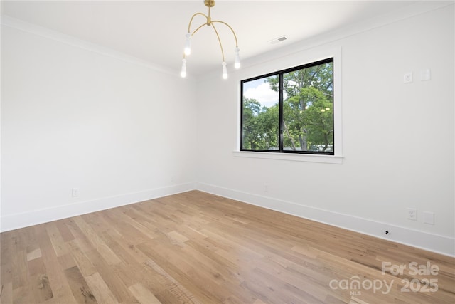 554 W Cama St, Charlotte, NC 28217 - empty room with baseboards, light wood-style flooring, a chandelier, and crown molding
